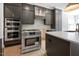 Contemporary kitchen featuring stainless steel appliances, gray cabinetry, and a center island at 8620 Dukes Lake Rd, Zebulon, NC 27597
