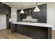 Modern kitchen with white countertops, dark cabinets, and stainless steel appliances at 8620 Dukes Lake Rd, Zebulon, NC 27597