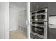 A modern kitchen features stainless steel appliances next to built-in mudroom storage and bench at 8620 Dukes Lake Rd, Zebulon, NC 27597