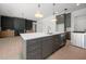 Kitchen showcasing a large island with seating, pendant lighting, and open-concept design at 8620 Dukes Lake Rd, Zebulon, NC 27597
