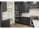Modern kitchen with stainless steel appliances, gray cabinets, and a convenient pantry area at 8620 Dukes Lake Rd, Zebulon, NC 27597