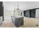 Spacious kitchen with large island, modern pendant lights, and an open layout at 8620 Dukes Lake Rd, Zebulon, NC 27597