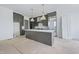 Spacious kitchen featuring modern gray cabinets, white countertops, and stainless steel appliances at 8620 Dukes Lake Rd, Zebulon, NC 27597