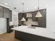Open kitchen featuring a large island, stainless steel appliances, and an open-concept design at 8620 Dukes Lake Rd, Zebulon, NC 27597