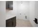 The laundry room features a counter top and cabinets and neutral color palette at 8620 Dukes Lake Rd, Zebulon, NC 27597