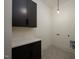 Compact laundry room with shaker cabinets and white countertop at 8620 Dukes Lake Rd, Zebulon, NC 27597