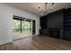 Elegant living room with a built-in bookcase, fireplace, and access to an outdoor deck at 8620 Dukes Lake Rd, Zebulon, NC 27597