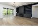 Living room showcasing the fireplace, built-in shelves, and sliding glass doors at 8620 Dukes Lake Rd, Zebulon, NC 27597