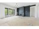 An unfurnished living room with a fireplace, shelving and sliding doors opening to the outside at 8620 Dukes Lake Rd, Zebulon, NC 27597