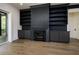 Living room featuring a fireplace, built-in shelves, hardwood floors, and neutral paint at 8620 Dukes Lake Rd, Zebulon, NC 27597
