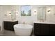 Elegant main bathroom boasting dual vanity sinks and a luxurious soaking tub at 8620 Dukes Lake Rd, Zebulon, NC 27597