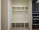 Mudroom with built-in shelving and seat paired with black cabinets and stainless steel appliances at 8620 Dukes Lake Rd, Zebulon, NC 27597