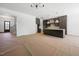 Open floor plan showing the kitchen with stainless steel appliances, custom cabinetry, and a center island at 8620 Dukes Lake Rd, Zebulon, NC 27597