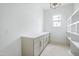 Spacious pantry with long countertop, cabinets, open shelving and a window for natural light at 8620 Dukes Lake Rd, Zebulon, NC 27597