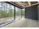 Covered back porch with a ceiling fan and wooden floors perfect for outdoor lounging at 8620 Dukes Lake Rd, Zebulon, NC 27597