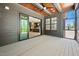 Spacious screened-in porch boasts a ceiling fan, and views through the sliding door to kitchen at 8620 Dukes Lake Rd, Zebulon, NC 27597