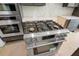 Stainless steel range with multiple burners and knobs in this modern, new construction kitchen at 8620 Dukes Lake Rd, Zebulon, NC 27597