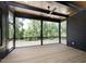 Beautiful screened porch with wood ceiling and ceiling fan overlooking backyard at 8620 Dukes Lake Rd, Zebulon, NC 27597