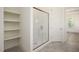 Shower with glass doors and wall shelving at 8620 Dukes Lake Rd, Zebulon, NC 27597