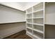 Spacious walk-in closet with custom shelving and racks for optimal organization at 8620 Dukes Lake Rd, Zebulon, NC 27597