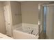 Bathroom with a soaking tub and walk-in shower at 8650 Neuse Landing Ln # 101, Raleigh, NC 27616
