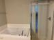 Bathroom featuring a walk-in shower and tub at 8650 Neuse Landing Ln # 101, Raleigh, NC 27616