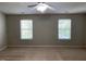 Spacious bedroom features two windows and ceiling fan at 8650 Neuse Landing Ln # 101, Raleigh, NC 27616