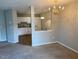Inviting dining area open to the kitchen, featuring a stylish chandelier and neutral decor at 8650 Neuse Landing Ln # 101, Raleigh, NC 27616