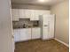 Practical kitchen featuring white cabinets and modern appliances adjacent to a functional eating area at 8650 Neuse Landing Ln # 101, Raleigh, NC 27616