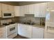 Functional kitchen featuring white cabinets, modern appliances, and ample countertop space at 8650 Neuse Landing Ln # 101, Raleigh, NC 27616
