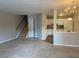 Spacious living room features neutral carpet, and a staircase to the upper level at 8650 Neuse Landing Ln # 101, Raleigh, NC 27616