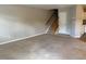 Spacious living room featuring neutral carpeting and stairs to the upper level at 8650 Neuse Landing Ln # 101, Raleigh, NC 27616