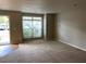 Spacious living area with abundant natural light and neutral carpeting, ideal for relaxing or entertaining at 8650 Neuse Landing Ln # 101, Raleigh, NC 27616