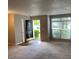 Bright living area featuring a large window, neutral walls and carpet, leading to a cozy entrance at 8650 Neuse Landing Ln # 101, Raleigh, NC 27616