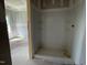 New bathroom area with tiled shower stall and shelving at 89 Grove Township Way, Angier, NC 27501