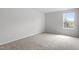 This bedroom features neutral walls, carpet flooring, and a window that brings in plenty of natural light at 89 Grove Township Way, Angier, NC 27501
