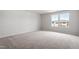 Bedroom featuring neutral walls and trim, carpet, and standard closet doors at 89 Grove Township Way, Angier, NC 27501
