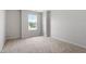 This bedroom features neutral walls, carpet flooring, and a large window that brings in plenty of natural light at 89 Grove Township Way, Angier, NC 27501