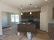Kitchen island with gray cabinets and a modern countertop is featured in the center at 89 Grove Township Way, Angier, NC 27501