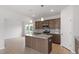 Bright kitchen featuring a central island, stainless steel appliances, and abundant cabinet space at 89 Grove Township Way, Angier, NC 27501