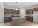 Modern kitchen with granite countertops, a central island, pendant lighting, and stainless steel appliances at 89 Grove Township Way, Angier, NC 27501