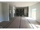 Living room featuring gray walls and an open-concept layout to the kitchen and dining areas at 89 Grove Township Way, Angier, NC 27501
