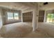 Unfinished living room space with multiple windows, exposed studs, and a support pillar at 89 Grove Township Way, Angier, NC 27501