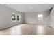 Spacious living room featuring hardwood floors, bright windows, and neutral-colored walls at 89 Grove Township Way, Angier, NC 27501