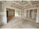 Large, unfinished living room space with doorway openings to other parts of the house and sliding glass doors at 89 Grove Township Way, Angier, NC 27501