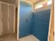 New shower stall with blue walls and concrete floor at 89 Grove Township Way, Angier, NC 27501