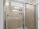 Shower with glass door, tile surround, niche, and shower head at 89 Grove Township Way, Angier, NC 27501