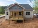 Newly constructed home featuring a cozy back porch, perfect for outdoor relaxation and entertaining at 90 Purslane Dr, Franklinton, NC 27525
