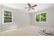 Cozy bedroom with two large windows offering a peaceful view of the outdoors at 90 Purslane Dr, Franklinton, NC 27525