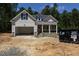 Charming home featuring stone accents, a covered front porch, and attached garage at 90 Purslane Dr, Franklinton, NC 27525